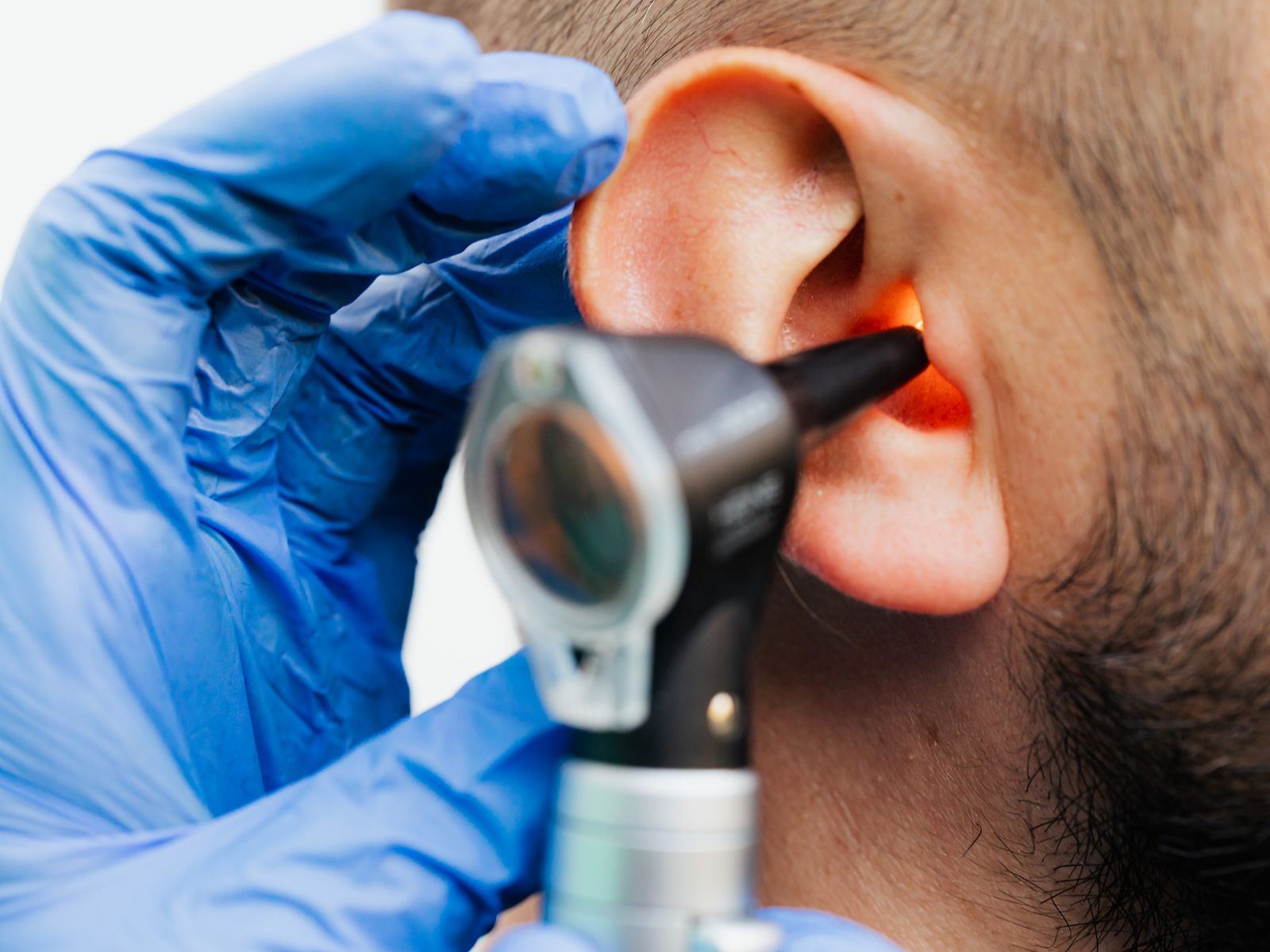 Close-up of an otoscope examining a person's ear.