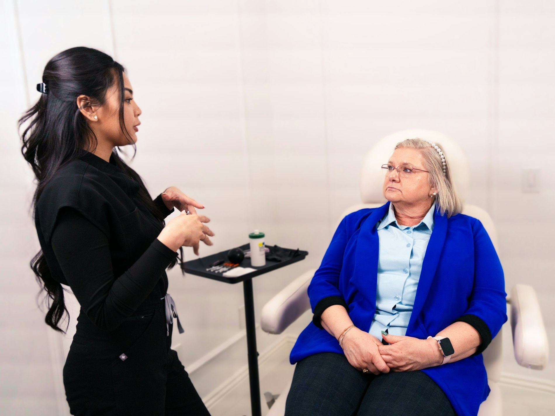 Clinician consulting with a seated client in a clinical room